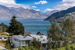 a house with a view of a lake and mountains at 13 Poole Lane by Staysouth in Queenstown