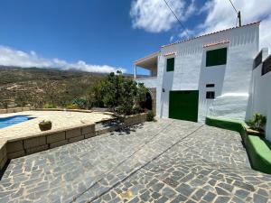 a villa with a swimming pool and a building at Casa Rural La Sombrera in Fasnia