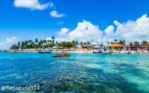 a view of a beach with boats in the water at Laguna Beach Flat 314- Porto de Galinhas in Porto De Galinhas