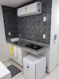a kitchen with a sink and a counter top at Laguna Beach Flat 314- Porto de Galinhas in Porto De Galinhas