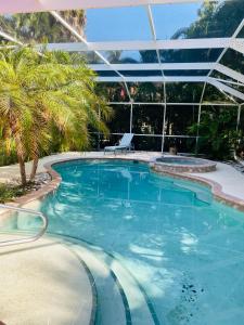 a large swimming pool with a pergola at Casey Key Beach & Tennis in Nokomis