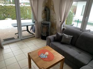 a living room with a couch and a table at Ferienhaus Elida in Krummin +17 photos
