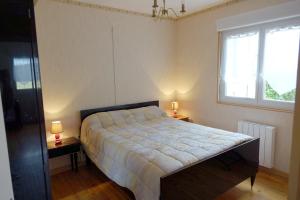 a bedroom with a bed and two lamps on two tables at La Crova in Félines