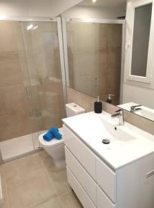 a bathroom with a sink and a toilet and a shower at Atalaya de Fornells in Fornells +16 photos