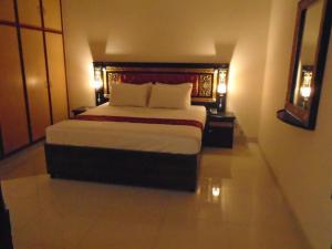 a bedroom with a large bed in a room at Lotus 1 Hotel in Lahore