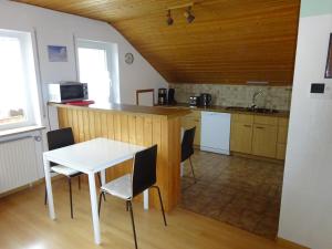 a kitchen with a table and chairs in a room at Ferienwohnung Bigi in Efringen-Kirchen