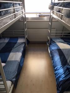 a room with two bunk beds and a window at Royal III in Knokke-Heist
