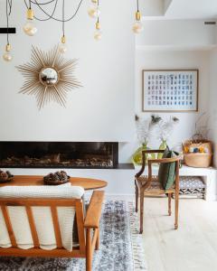 a living room with a table and a fireplace at La Maison Odeia Bordeaux Centre in Bordeaux