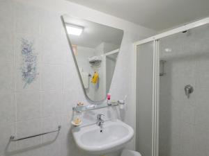 a bathroom with a sink and a shower with a mirror at Hotel City in Misano Adriatico +42 photos