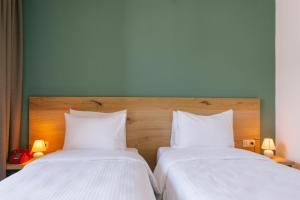 Ένα ή περισσότερα κρεβάτια σε δωμάτιο στο Intourist Kazbegi