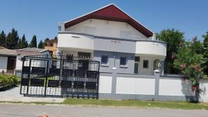 a white house with a balcony on a street at Studios Velika Plaža in Ulcinj