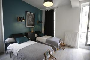 Postel nebo postele na pokoji v ubytování L'APPART LE 5