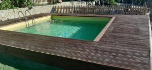 a small swimming pool with a wooden deck at Ca' De Angiolina in Sanremo