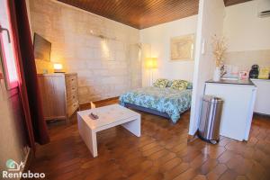 a small bedroom with a bed and a table at Chanteloche CLIM Netflix Disney by Rentabao in Avignon