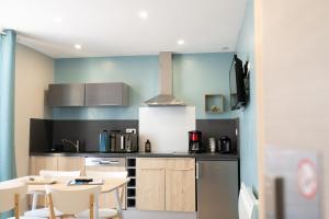 a kitchen with a table and chairs in a room at O2 Horizon in Le Tréport