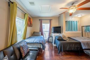 a living room with two beds and a couch at East Downtown Bungalow in Houston