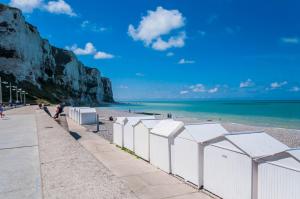 a beach with a white fence and the ocean at O2 Horizon in Le Tréport