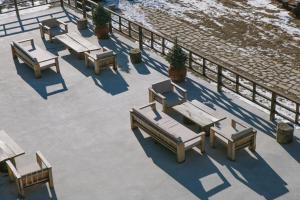 a group of picnic tables and benches on a patio at Intourist Kazbegi in Stepantsminda