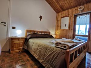 ein Schlafzimmer mit einem großen Bett und einem Fenster in der Unterkunft Roccaraso centro in Roccaraso