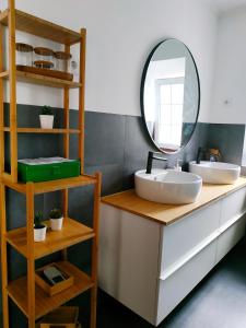 a bathroom with two sinks and a mirror on a counter at Janela do Porto in Prainha de Baixo