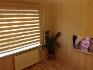 a room with a window with a picture of a woman at Samson Apartments in Velikiy Novgorod