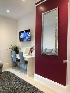 a dining room with a mirror and a table at The Dragon Pad Boutique Apartment in Royal Tunbridge Wells