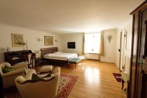 a living room with a bed and a couch at Goldgasse Apartments de Luxe in Salzburg