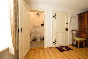 a bathroom with a toilet and a door at Goldgasse Apartments de Luxe in Salzburg