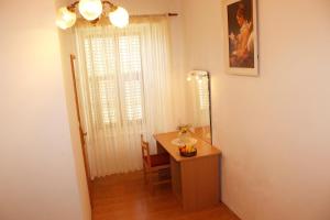 a room with a desk and a mirror and a window at Rooms Lazareti in Dubrovnik +13 photos