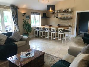 a living room with a couch and a table at Walnut Tree Cottage Barn in Toppesfield