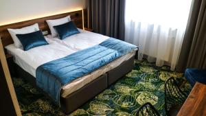 Postel nebo postele na pokoji v ubytování Bloom Hotel Airport Okęcie