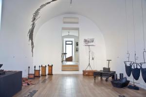 a large white room with an archway in a building at Pestana Cidadela Cascais - Pousada & Art District in Cascais
