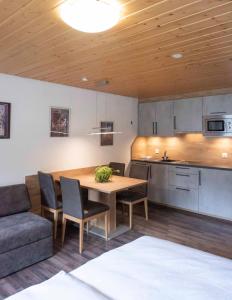 a kitchen and dining room with a table and a couch at Apartment Madlaina in Samnaun