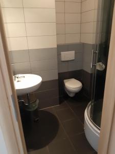 a small bathroom with a toilet and a sink at Maris Pokoje Gościnne in Łeba