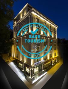 a building with a blue sign on the side of it at Dencity Hotels & Spa in Istanbul