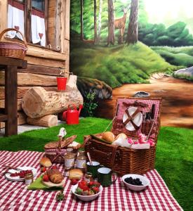 a picnic table with food and baskets and a painting at URBAN PIC NIC in Piazza Brembana