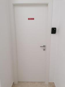 a white door with a sign on it at Tanzi Home in Bari