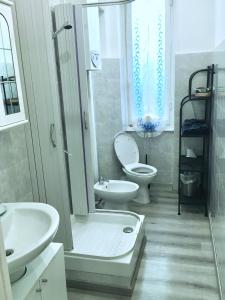 a bathroom with a toilet and a sink and a shower at Delicious House Genova in Genova +24 photos