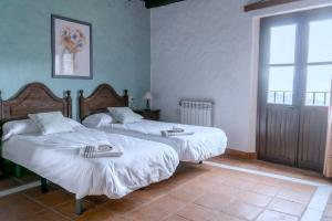 A bed or beds in a room at Hotel Almejí