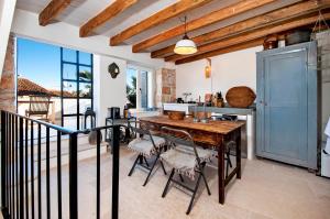 a kitchen with a wooden table and some chairs at Monte Sea View Residence with terrace in Rovinj