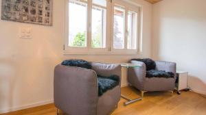 a room with two chairs and a table and a window at Studio Riseten in Adelboden