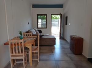 a living room with a table and a couch at CASA Naranja.RR in Barrio San Isidro (2)