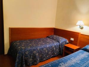 Postel nebo postele na pokoji v ubytování Hotel Ferrari