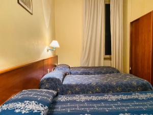Postel nebo postele na pokoji v ubytování Hotel Ferrari