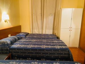 Postel nebo postele na pokoji v ubytování Hotel Ferrari