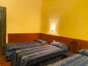Postel nebo postele na pokoji v ubytování Hotel Ferrari