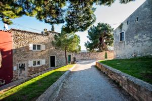 an external view of a stone building with a driveway at Monte Sea View Residence in Rovinj