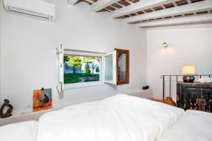 a white bedroom with a bed and a window at Monte Sea View Residence in Rovinj