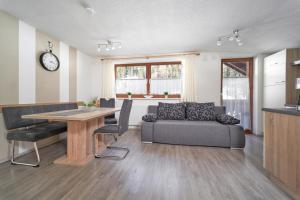 a living room with a table and a couch at Appartement Natalie in Längenfeld