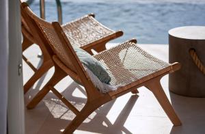 a wicker chair sitting next to a table at Artemis Seaside Resort in Paliochori